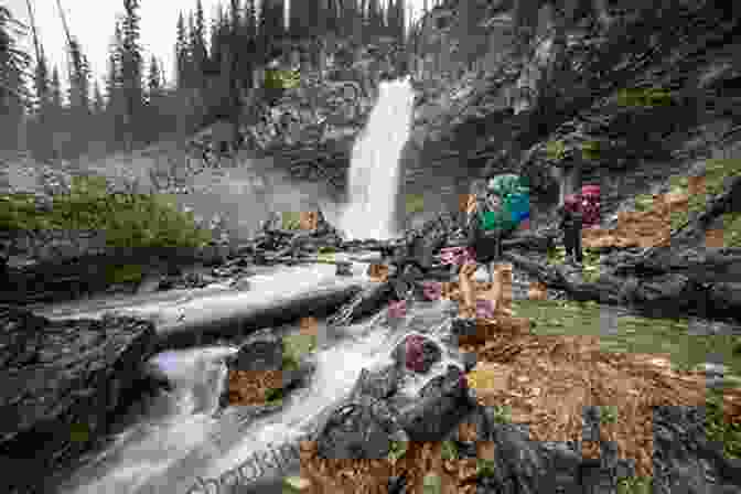 A Group Of Hikers Admiring A Majestic Waterfall Waterton Lakes National Park Hiking Guide