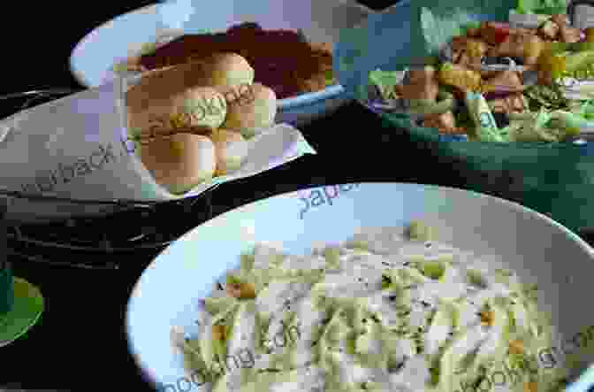 Image Of Olive Garden Restaurant With A Bowl Of Pasta And Breadsticks In The Foreground Copycat Recipes Making The Most Popular Dishes From Favorite Restaurants At Home : Cheesecake Factory Applebee S PF Chang S Olive Garden Red Bread (Famous Restaurant Copycat Cookbooks)